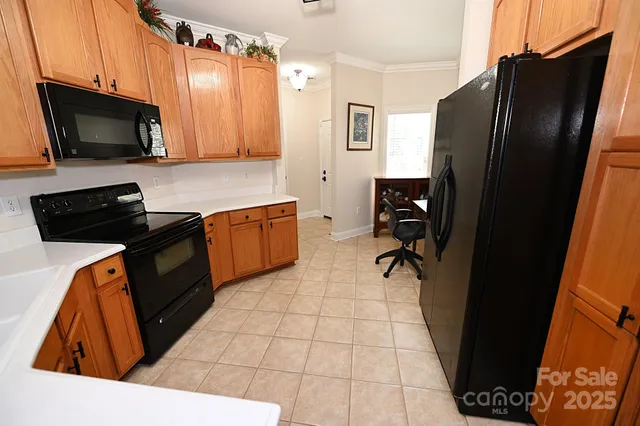 a kitchen with stainless steel appliances a stove sink microwave and cabinets