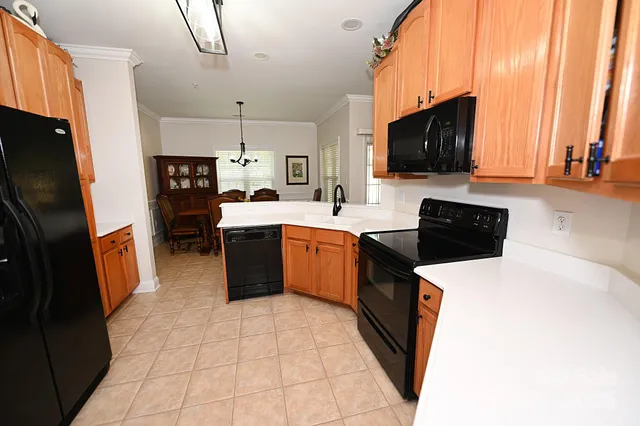 a kitchen with stainless steel appliances a sink dishwasher stove and cabinets
