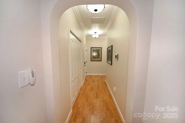 a bedroom with a large bed and a flat tv screen on dresser