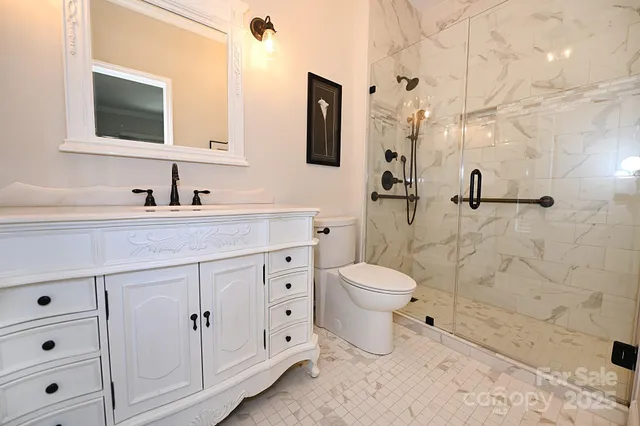 a bathroom with a sink a toilet and a mirror