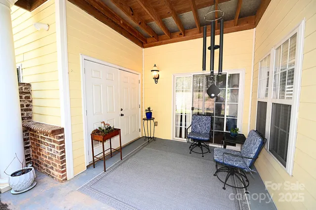 a view of a patio with table and chairs and potted plants