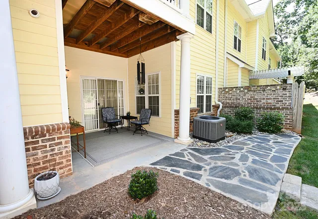 a view of a livingroom with couch and a potted plant
