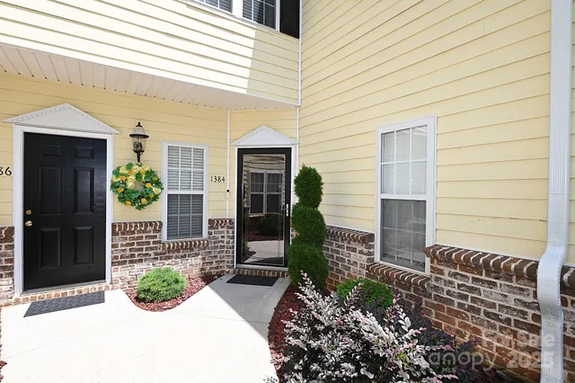 a living room with furniture a bed and a chandelier