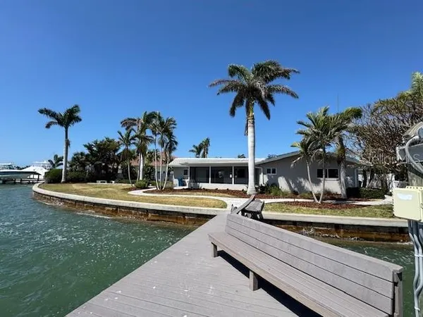 a view of a house with pool and chairs