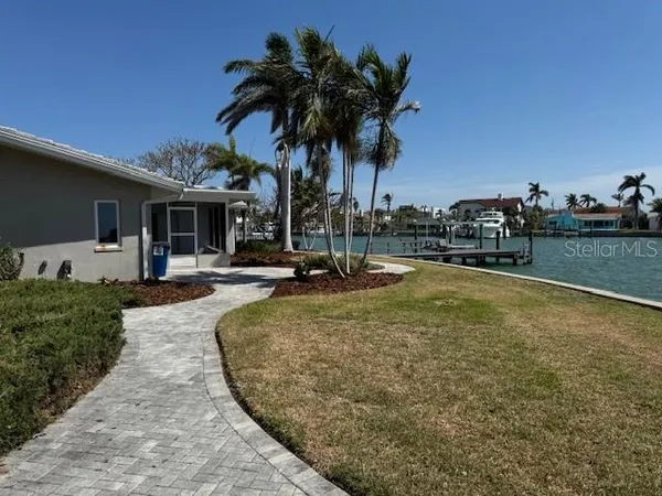 a view of a swimming pool with a patio and a yard