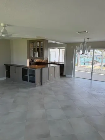 a large kitchen with a stove and large window