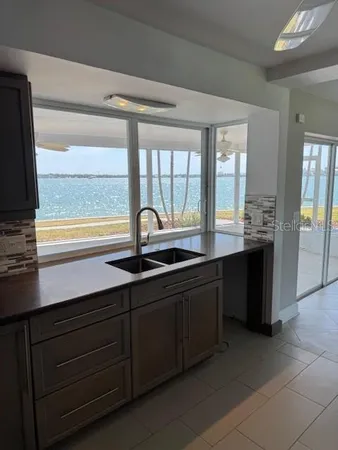 a kitchen with a sink and large window