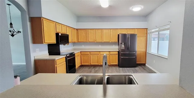 a kitchen with stainless steel appliances a sink a microwave a stove and refrigerator