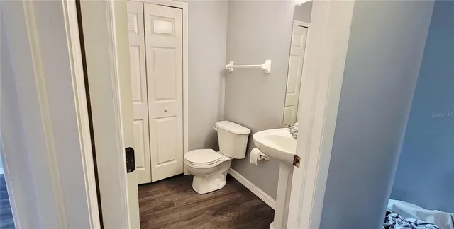 a white toilet sitting next to a bathroom sink