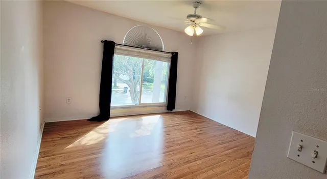 wooden floor in an empty room with a window