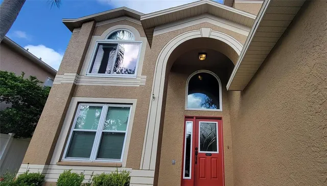 a view of a brick house with large windows