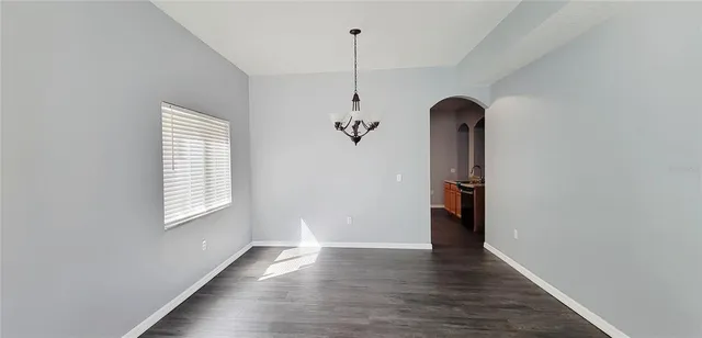 a view of a room with wooden floor and windows