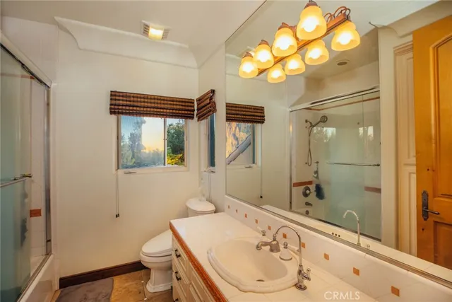 a bedroom with a bed next to a window