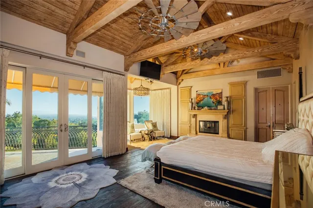 a living room with furniture pool table and wooden floor