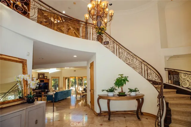 a dining hall with stainless steel appliances granite countertop a table chairs and a refrigerator