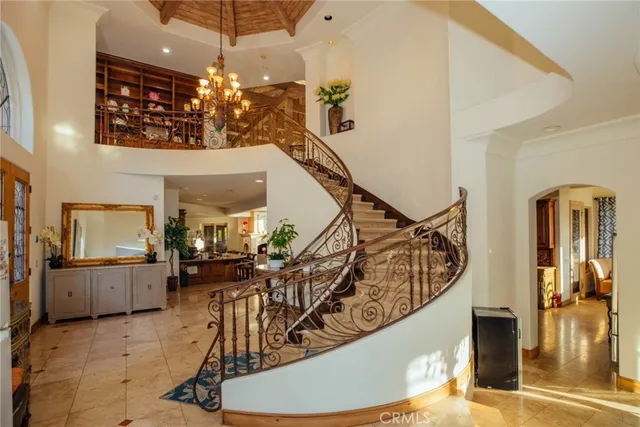 a living room with lots of tables a large window and chairs