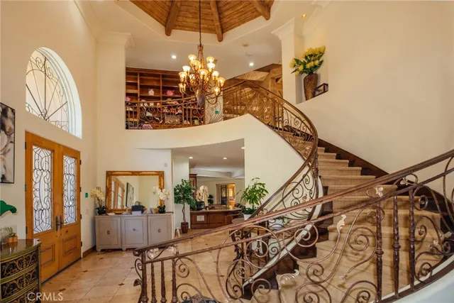 a living room with furniture a fireplace and large windows