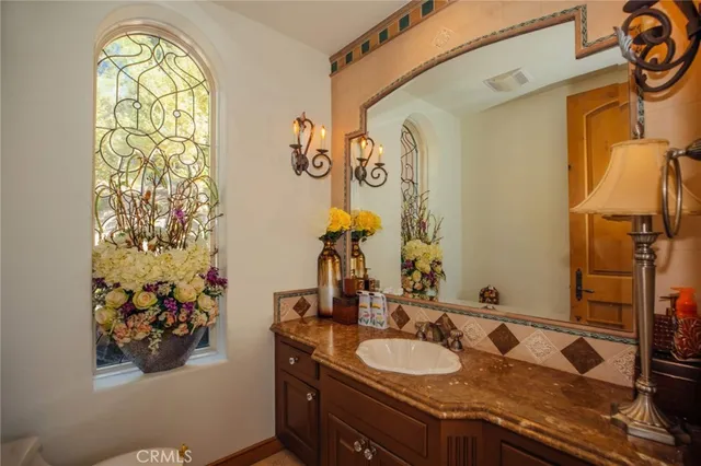 a large white kitchen with a large window and stainless steel appliances