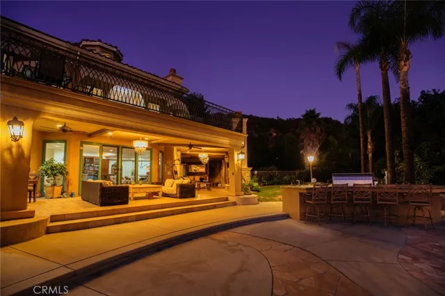 a bedroom with a large bed and a large window with wooden floor