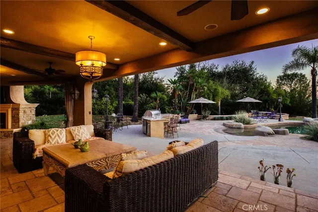 a bedroom with a large bed and a chandelier fan