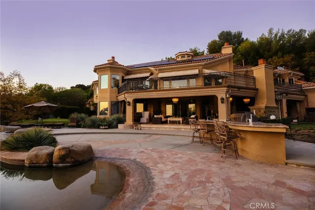 a bed sitting in a spacious bedroom next to a fireplace