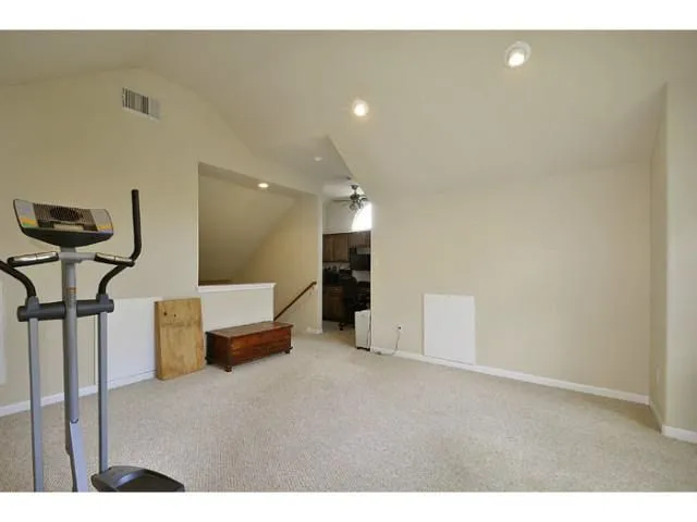 a living room with furniture and a ceiling fan