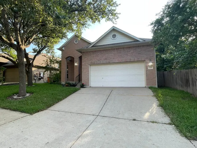 a front view of house with yard garage and green space