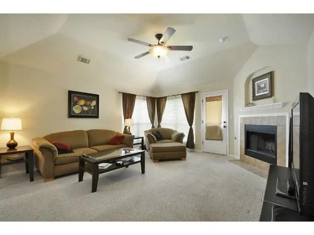 a living room with furniture and a fireplace