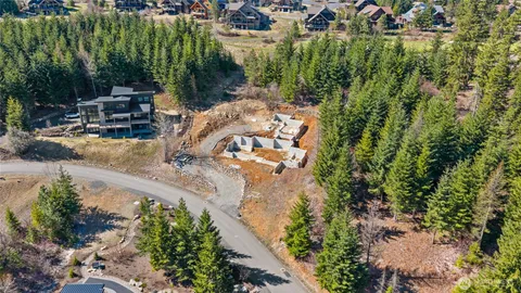 an aerial view of a house with a yard basket ball court and outdoor seating