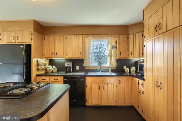 a kitchen with a sink stove and refrigerator