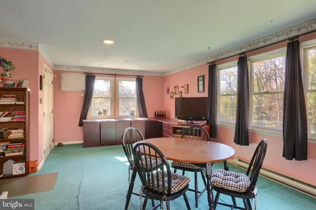 a view of a dining room with furniture and window