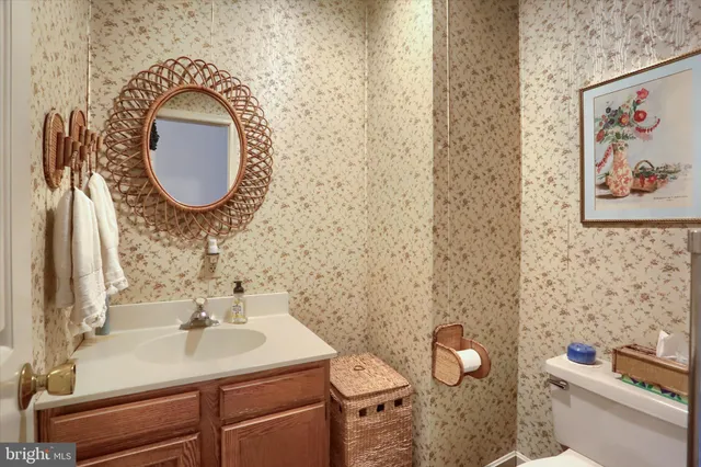 a bathroom with a sink mirror vanity and toilet