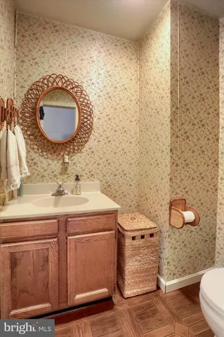 a bathroom with a sink a toilet and mirror