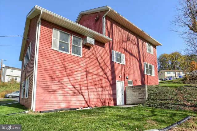 a view of a backyard with wooden fence