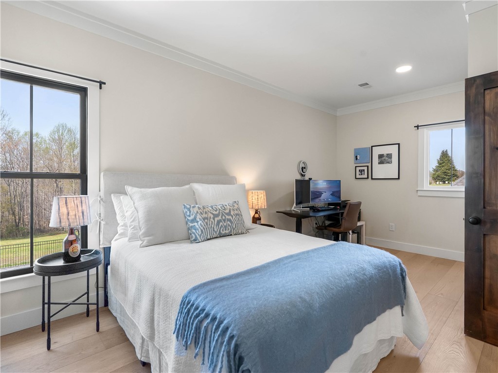 331 Bakerville Road Easley, SC 29642 - Photo 26 of 43 This tranquil bedroom features light wood flooring, large windows, and clean, inviting aesthetics.