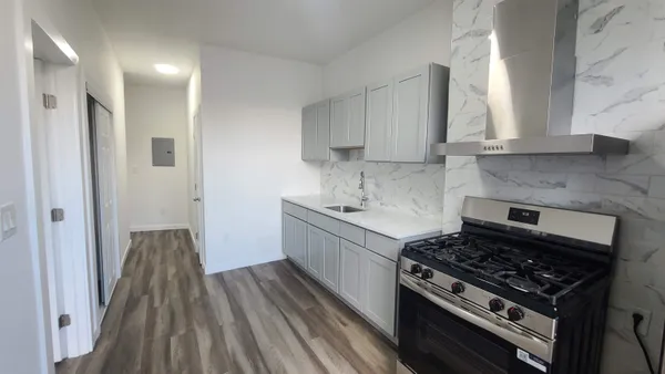 a kitchen with sink stove and cabinets