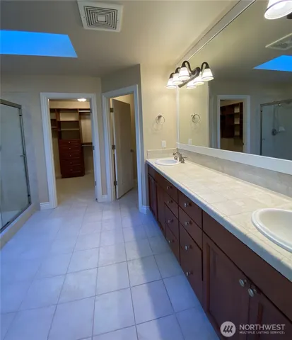 a large bathroom with a sink and a large mirror