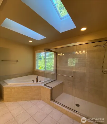 a bathroom with a bathtub and a shower