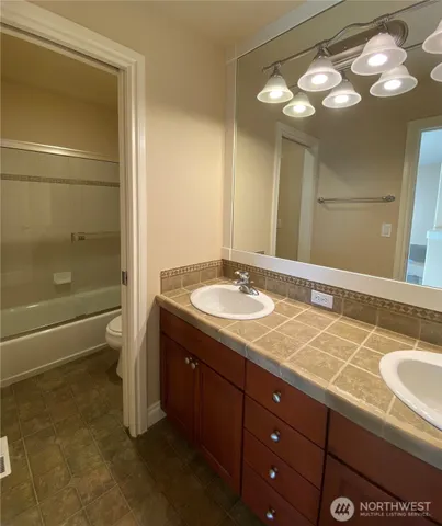 a bathroom with a sink double vanity and a mirror