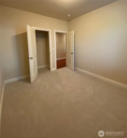an empty room with closet area