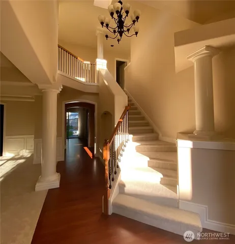 a view of entryway and hall with wooden floor