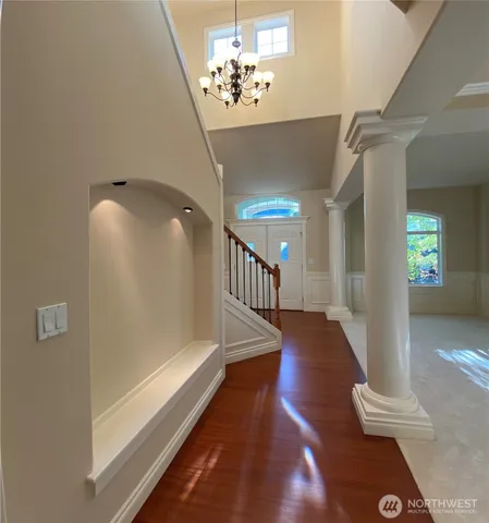 a view of entryway and hall with wooden floor
