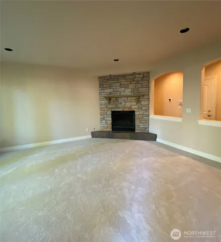 a view of empty room with a fireplace