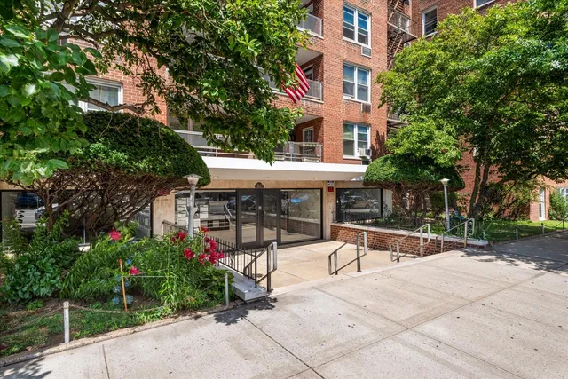 a view of a patio with a table and chairs under an umbrella
