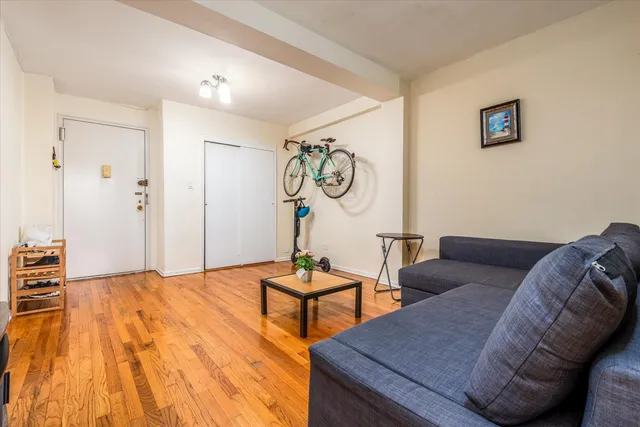 a bedroom with furniture and wooden floor