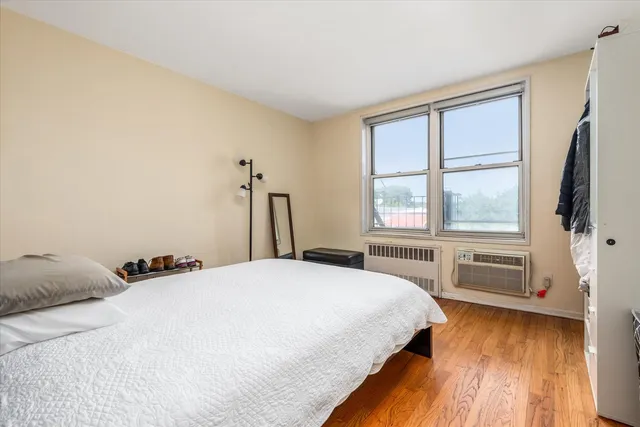 a bedroom with a bed and a large window