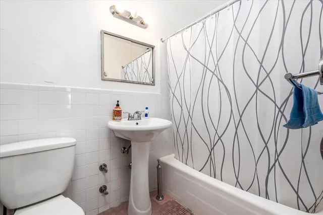 a bathroom with a sink toilet and mirror