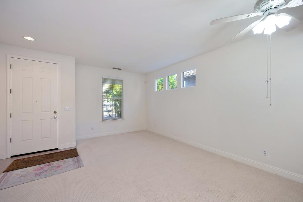 3930 Riley Anton Way Rancho Cordova, CA 95742 - Photo 12 of 45 an empty room with windows and chandelier fan