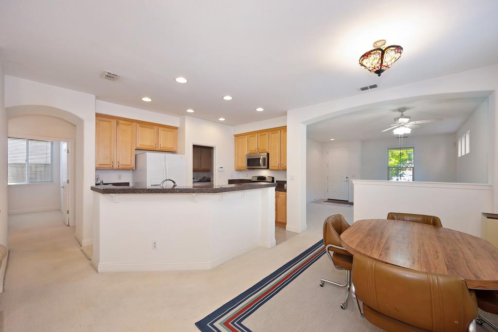 3930 Riley Anton Way Rancho Cordova, CA 95742 - Photo 16 of 45 a living room with stainless steel appliances furniture a rug and a kitchen view