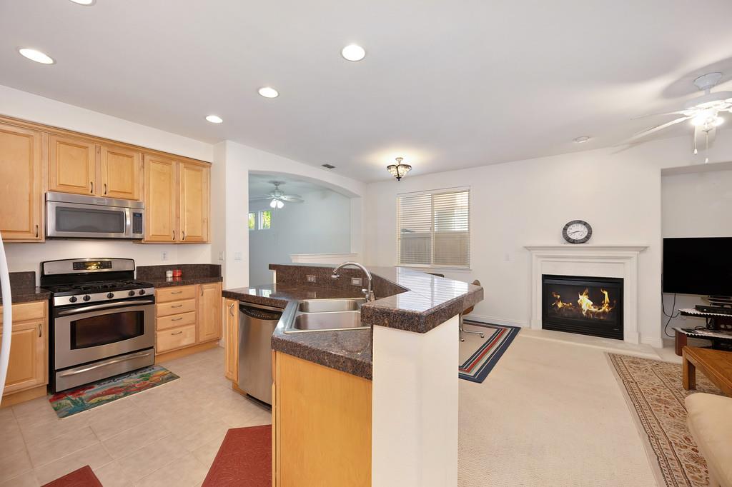 3930 Riley Anton Way Rancho Cordova, CA 95742 - Photo 18 of 45 a kitchen with microwave a stove and cabinets